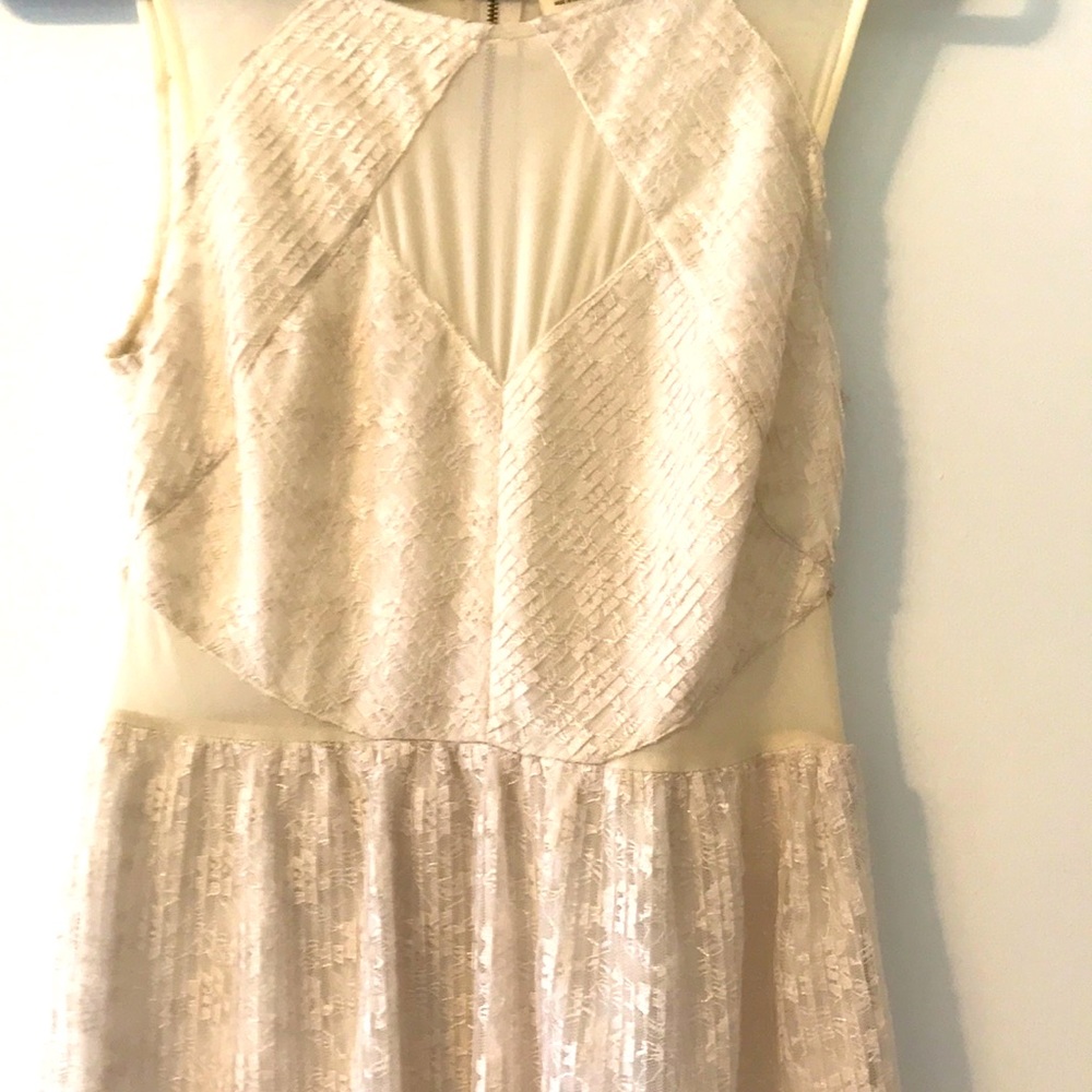 Creamy lace dress with sheer cutouts.
